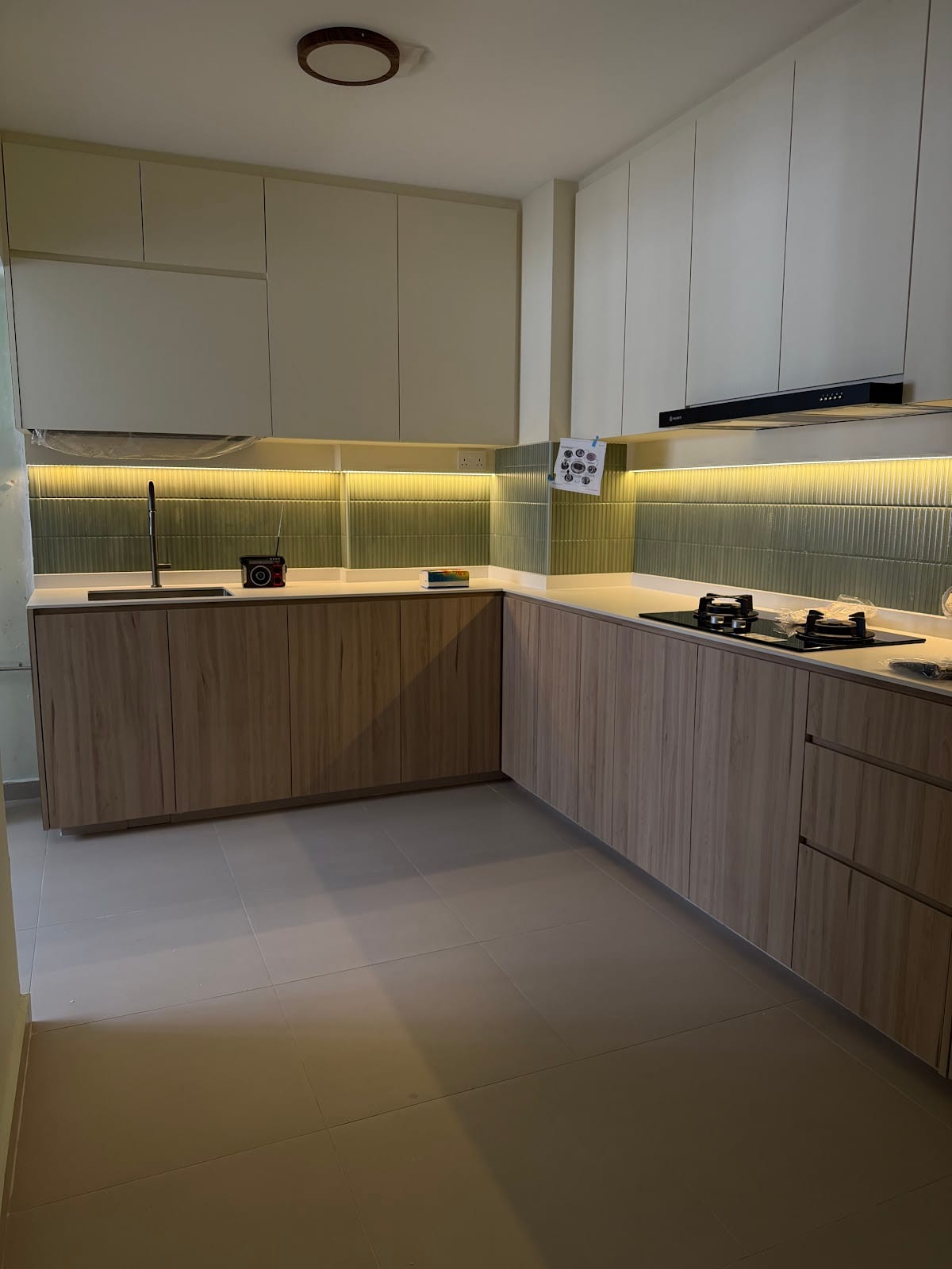Contemporary kitchen cabinetry renovation with seamless quartz countertop and subway backsplash
